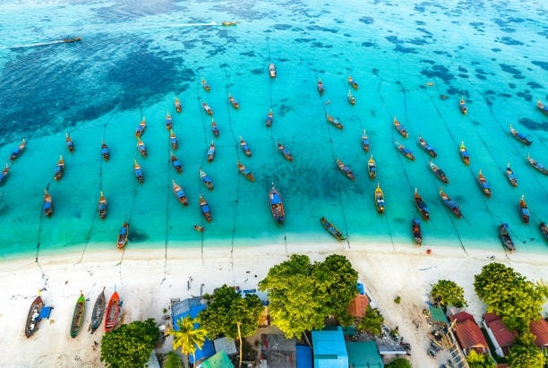 Aerial view of Sunrise Beach with longtail boats in Koh Lipe, Satun, Thailand