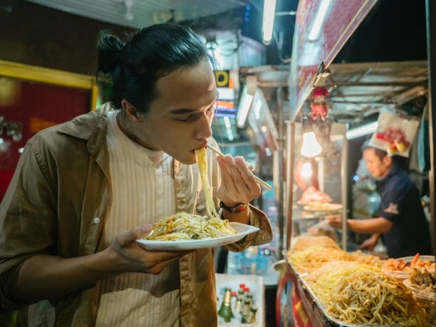 Asian Man Enjoying Food