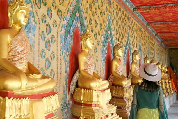 Female Visitor at the Cloister with Large Group of Seated Buddha