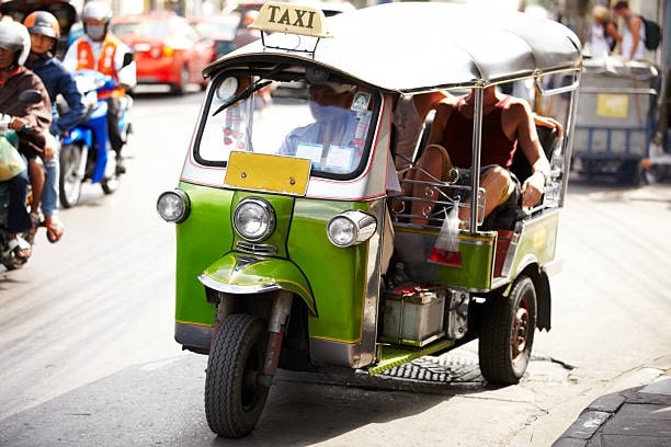 How does one ride a tuk tuk in Thailand