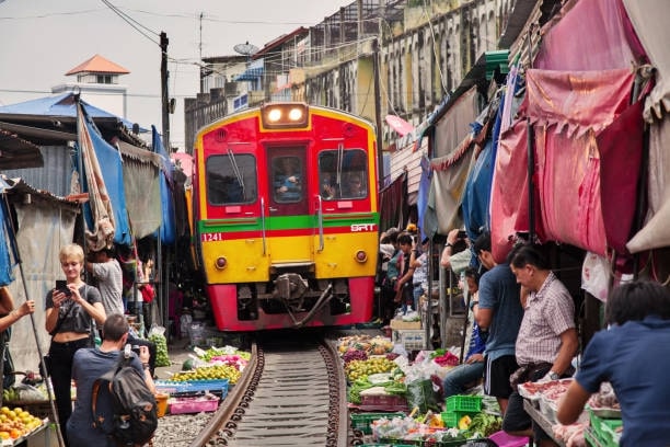 Shop and sample street foods at MaeKlong Railway Market