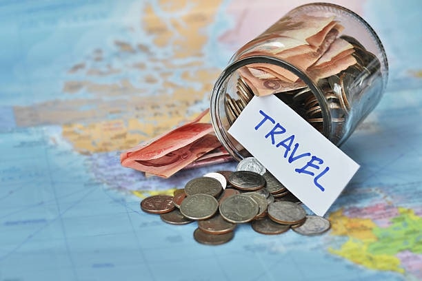 Travel budget - vacation money savings in a glass jar